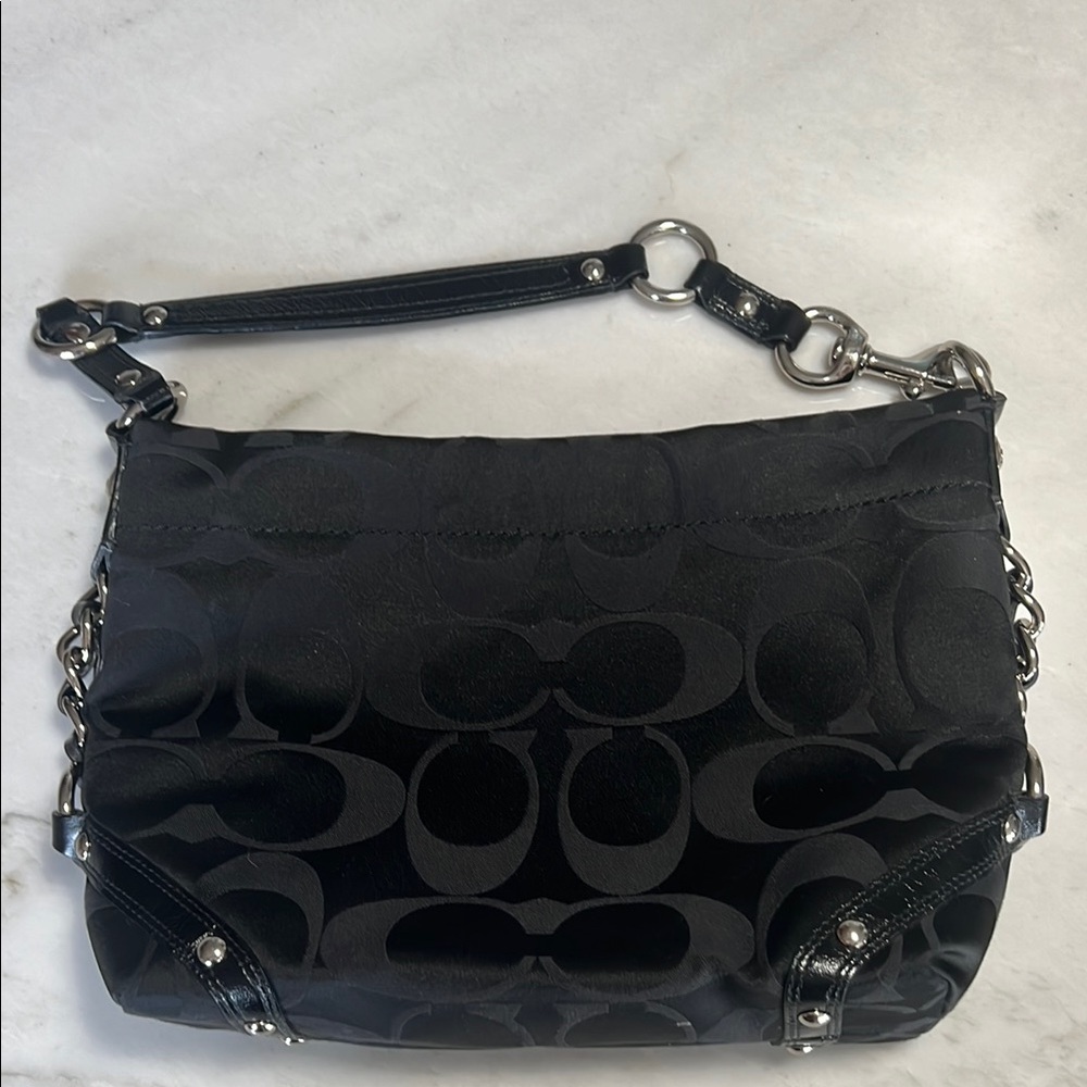 Black monogrammed Coach shoulder bag with silver hardware